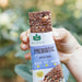 Lady holding Prebiotic Wholefood Bar Chocolate Almond & Coconut