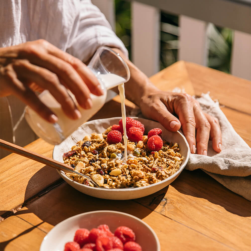 Milk pouring on Toasted Muesli with Cranberry