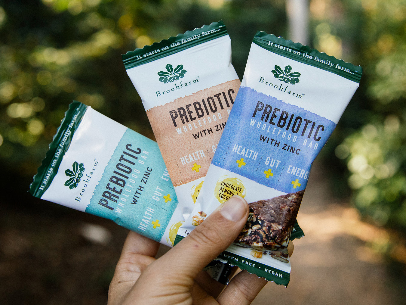 Woman holding Prebiotic Wholefood Bars with Zinc in sub-tropical rainforest